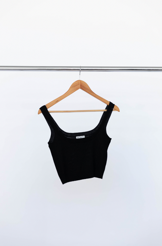 Black merino wool singlet on clothes hanger