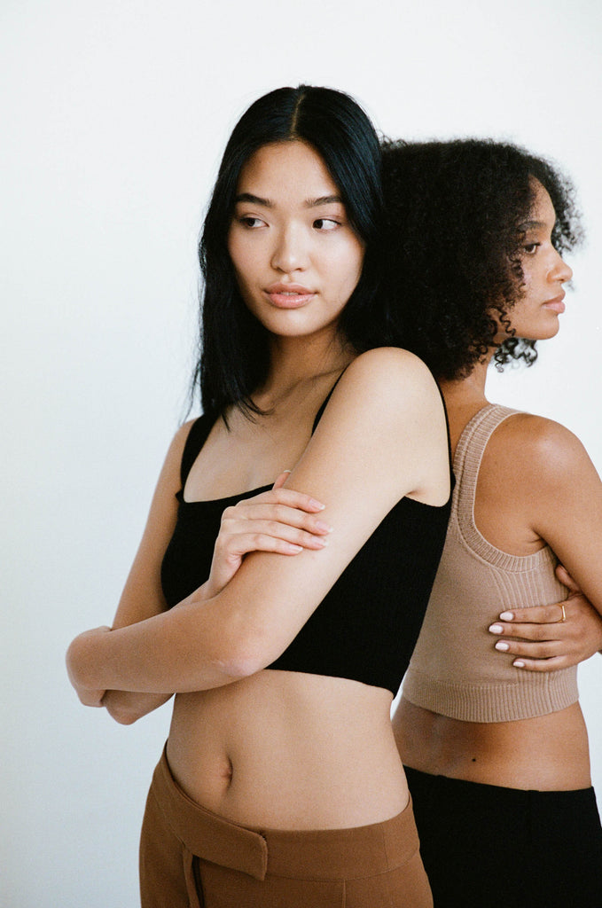 Models back to back wearing INTACT signature singlets